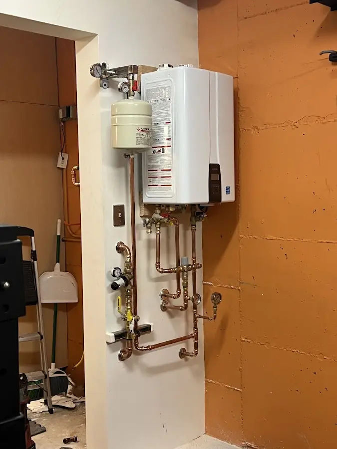 Plumbing technician inspecting water heater connections in Elizabethton